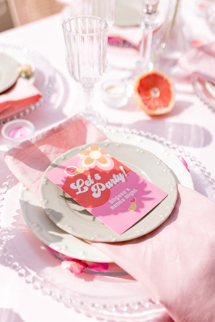 A stylish table setup with invitations and grapefruit slices, perfect for a spring party.