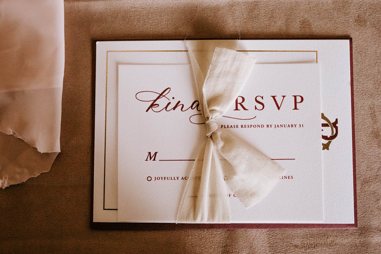An elegant wedding RSVP invitation card with a tied bow, perfect for a special occasion.
